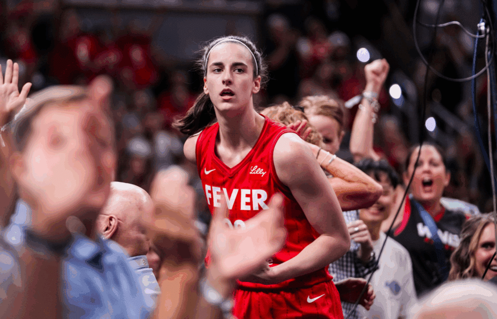 Indiana Fever guard Caitlin Clark (22) celebrates with fans behind the basket Friday, Aug. 16, 2024, during the game at Gainbridge Fieldhouse in Indianapolis.