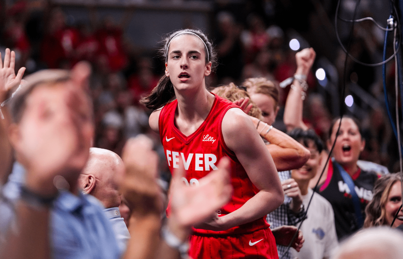 Indiana Fever guard Caitlin Clark (22) celebrates with fans behind the basket Friday, Aug. 16, 2024, during the game at Gainbridge Fieldhouse in Indianapolis.