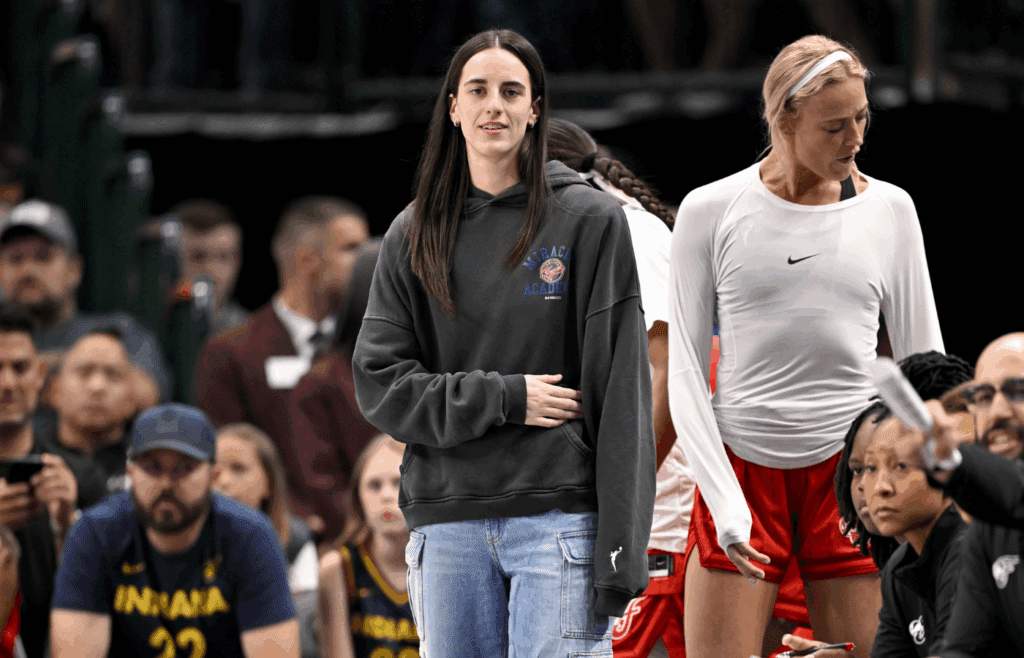 Jun 27, 2025; Dallas, Texas, USA; Indiana Fever guard Caitlin Clark (22) looks on from the team bench during the game against the Dallas Wings at the American Airlines Center. Mandatory Credit: Jerome Miron-Imagn Images