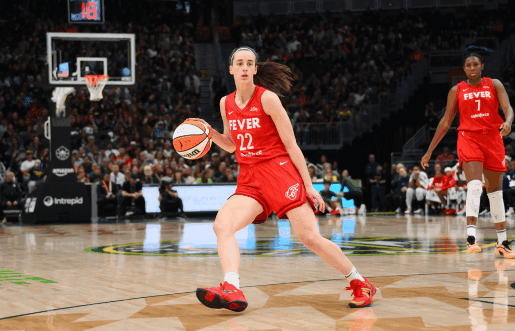 Jun 24, 2025; Seattle, Washington, USA; Indiana Fever guard Caitlin Clark (22) dribbles the ball against the Seattle Storm during the second half at Climate Pledge Arena. Mandatory Credit: Steven Bisig-Imagn Images
