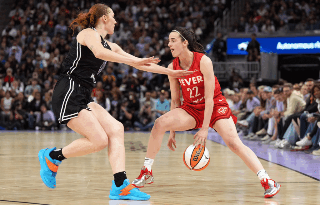 Jun 19, 2025; San Francisco, California, USA; Indiana Fever guard Caitlin Clark (22) dribbles against Golden State Valkyries forward Chloe Bibby (left) during the fourth quarter at Chase Center. Mandatory Credit: Darren Yamashita-Imagn Images