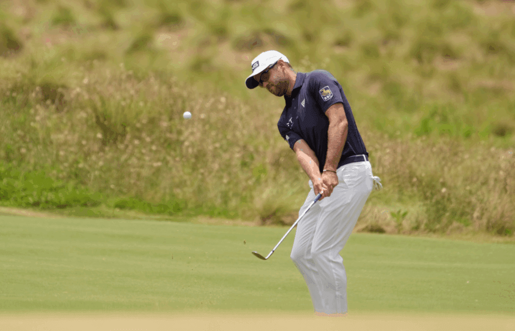 Jun 16, 2024; Pinehurst, North Carolina, USA; Corey Conners chips onto the first green during the final round of the U.S. Open golf tournament. Mandatory Credit: John David Mercer-Imagn Images
