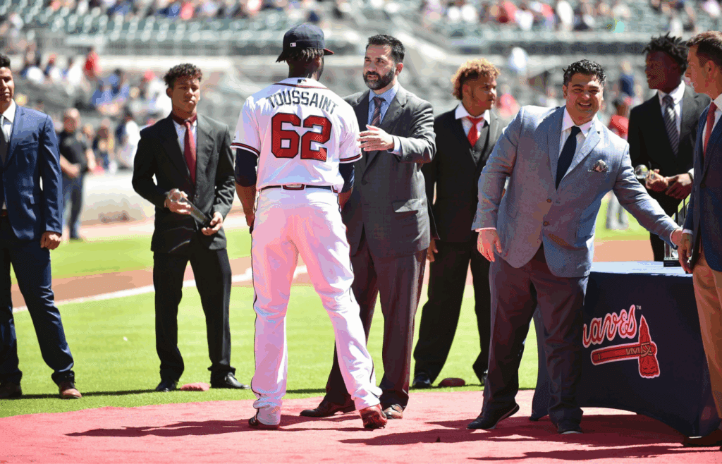 Sep 15, 2018; Atlanta, GA, USA; Atlanta Braves general manger Alex Anthopoulos greets Atlanta Braves starting pitcher Touki Toussaint (62) on the field prior to the game against the Washington Nationals at SunTrust Park. Mandatory Credit: Adam Hagy-Imagn Images