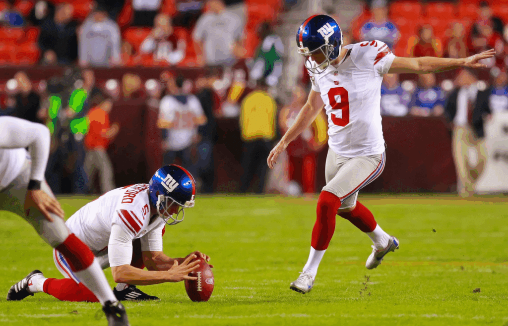 December 3, 2012; Landover, MD, USA; New York Giants kicker Lawrence Tynes (9) kicks the ball during warm ups prior to the Giants' game against the Washington Redskins at FedEx Field. Mandatory Credit: Geoff Burke-Imagn Images