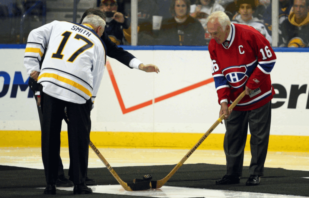 Oct 15, 2010; Buffalo, NY, USA; Former Montreal Canadiens legend Henri Richard (16) takes part in a ceremonial puck drop alongside Buffalo Sabres former player Floyd Smith (17), commemorating the 40th anniversary of the Buffalo Sabres before a game at HSBC Arena. Mandatory Credit: Timothy T. Ludwig–Imagn Images.
