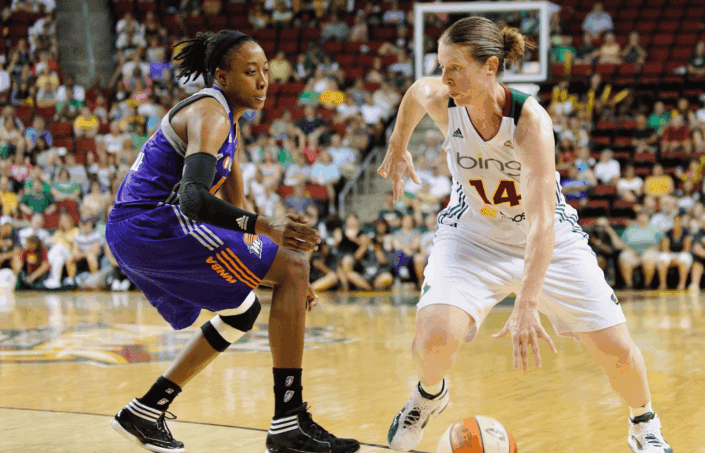 Aug 16, 2012; Seattle, WA, USA; Seattle Storm guard Katie Smith (14) dribbles past Phoenix Mercury guard Alexis Hornbuckle (14) during the 1st half at KeyArena. Seattle defeated Phoenix 72-58. Mandatory Credit: Steven Bisig-Imagn Images