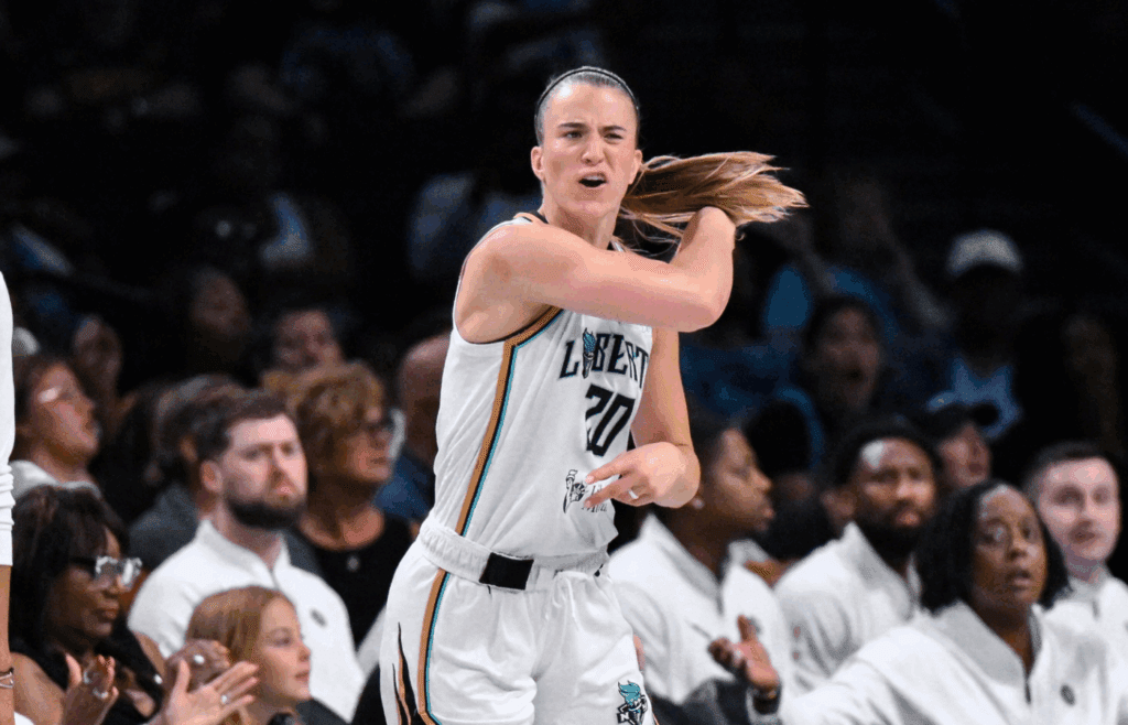 Jul 6, 2025; Brooklyn, New York, USA; New York Liberty guard Sabrina Ionescu (20) reacts during the first half against the Seattle Storm at Barclays Center. Mandatory Credit: John Jones-Imagn Images
