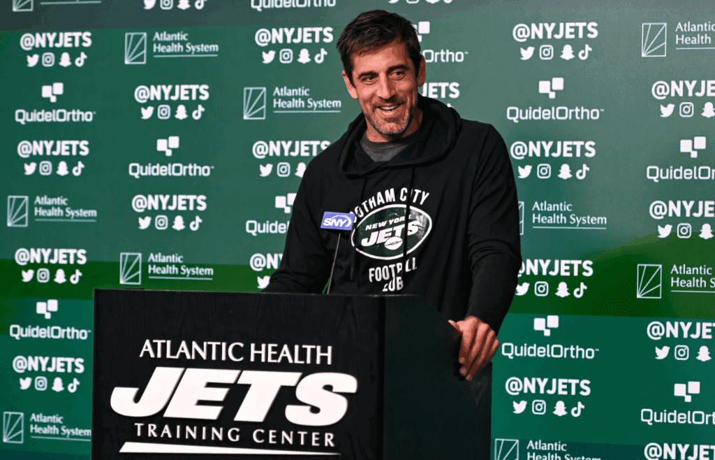 May 23, 2023; Florham Park, NJ, USA; New York Jets quarterback Aaron Rodgers (8) speaks at a press conference after practice at Atlantic Health Jets Training Center. Mandatory Credit: John Jones-Imagn Images