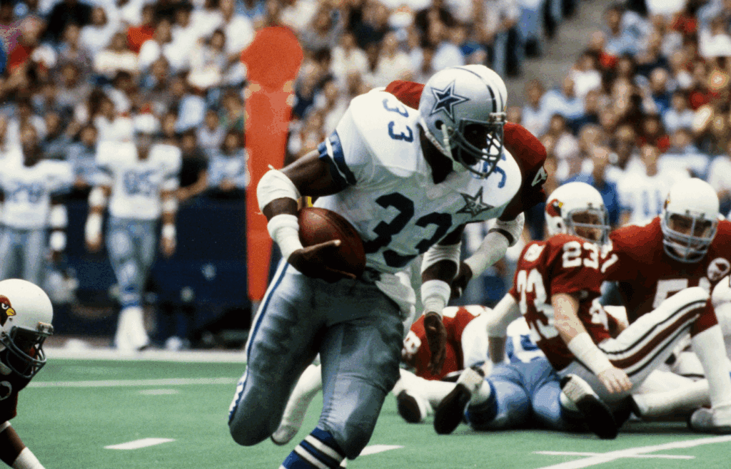 Oct 7, 1984; Irving, TX, USA; FILE PHOTO; Dallas Cowboys running back Tony Dorsett (33) carries the ball against the St Louis Cardinals at Texas Stadium. Mandatory Credit Herb Weitman-Imagn Images