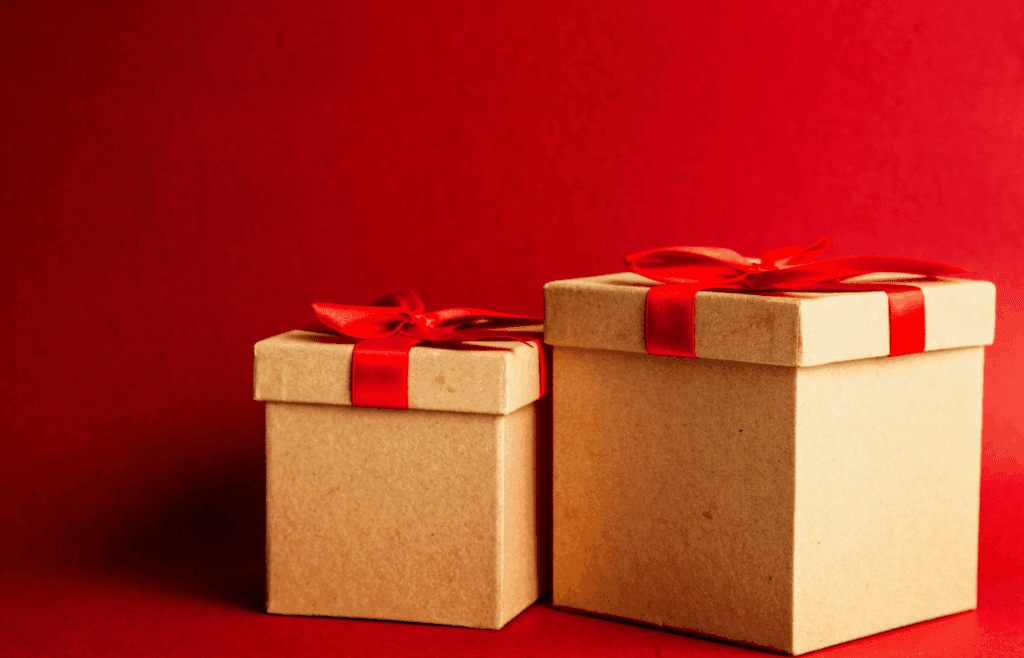 Two Wrapped Gifts on Red Surface