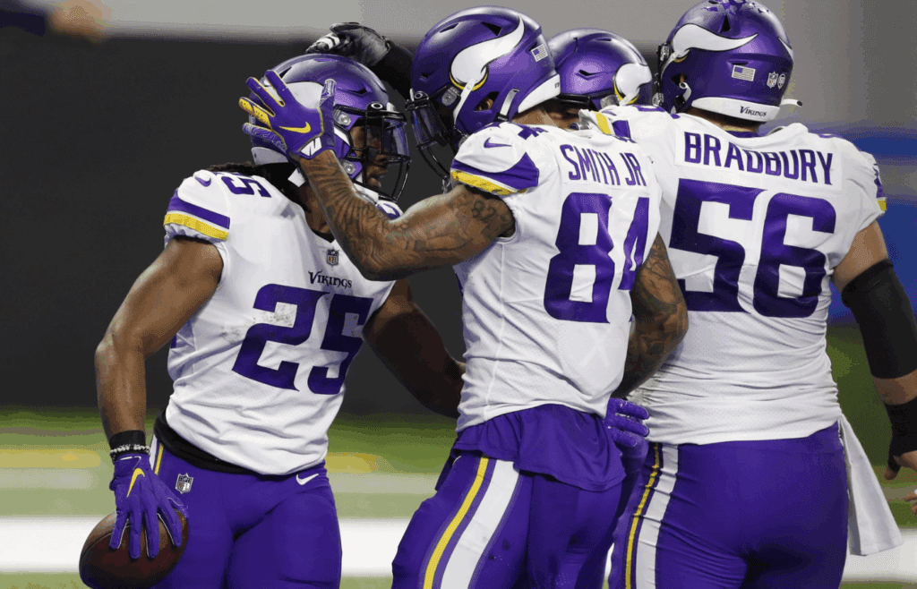 Jan 3, 2021; Detroit, Michigan, USA; Minnesota Vikings running back Alexander Mattison (25) celebrates with fullback C.J. Ham (behind) center Garrett Bradbury (56) and tight end Irv Smith (84) after scoring a touchdown during the first quarter against the Detroit Lions at Ford Field. Mandatory Credit: Raj Mehta-Imagn Images