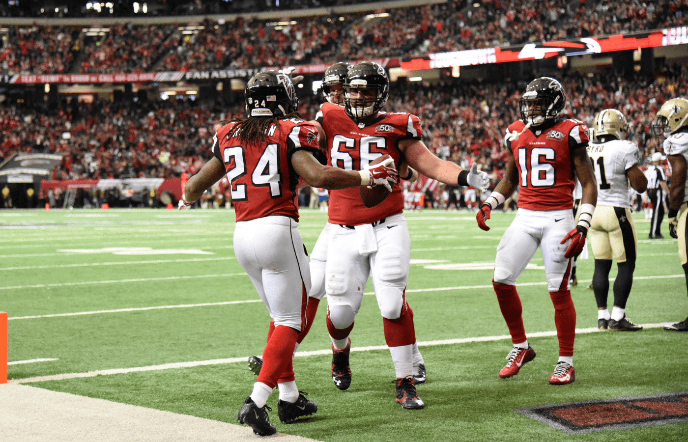 Jan 3, 2016; Atlanta, GA, USA; Atlanta Falcons running back Devonta Freeman (24) celebrates with center Gino Gradkowski (66) after catching a touchdown pass against the New Orleans Saints during the second quarter at the Georgia Dome. Mandatory Credit: Dale Zanine-Imagn Images