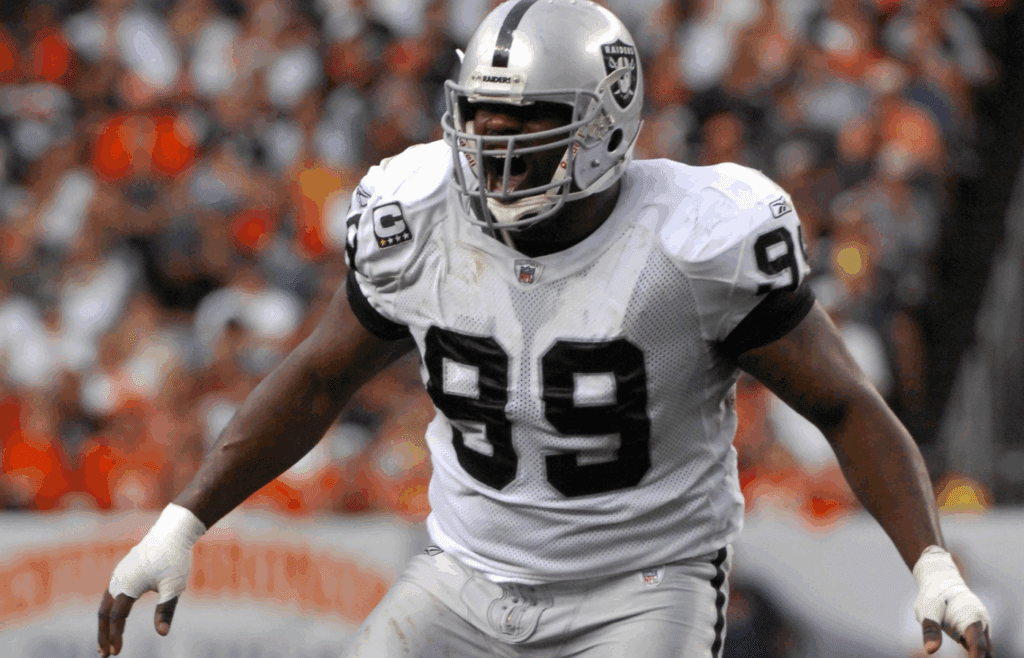 Sep 16, 2007; Denver, CO, USA; Oakland Raiders defensive tackle Warren Sapp (99) celebrates a tackle during 23-20 overtime loss to Denver Broncos at Invesco Field at Mile High. Mandatory Credit: Kirby Lee/Image of Sport-Imagn Images