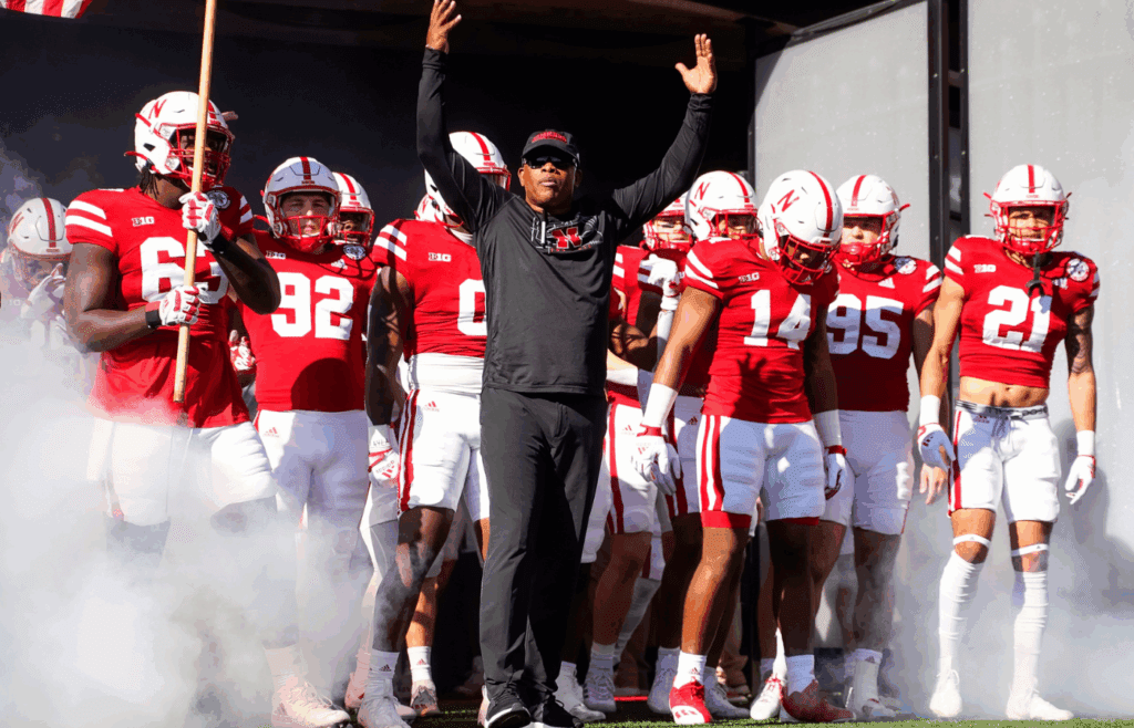 Oct 29, 2022; Lincoln, Nebraska, USA; Nebraska Cornhuskers interim head coach Mickey Joseph pumps up the crowd as the team exits the tunnel before the game against the Illinois Fighting Illini at Memorial Stadium. Mandatory Credit: Dylan Widger-Imagn Images