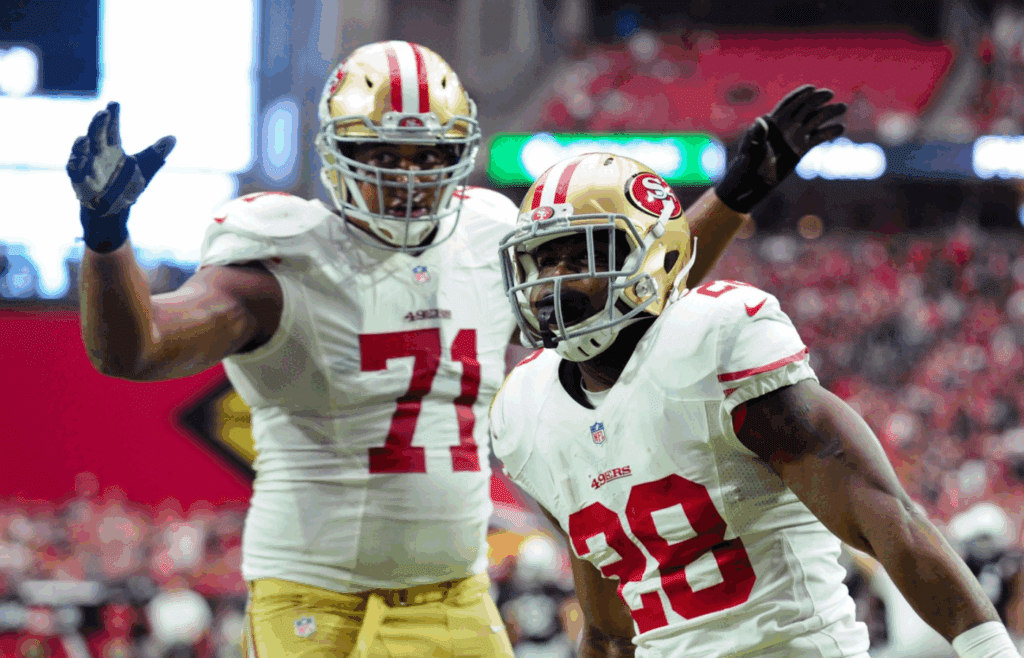 Sep 21, 2014; Glendale, AZ, USA; San Francisco 49ers running back Carlos Hyde (28) celebrates with tackle Jonathan Martin (71) after scoring a 6 yard touchdown during the first half against the Arizona Cardinals at University of Phoenix Stadium. Mandatory Credit: Matt Kartozian-Imagn Images