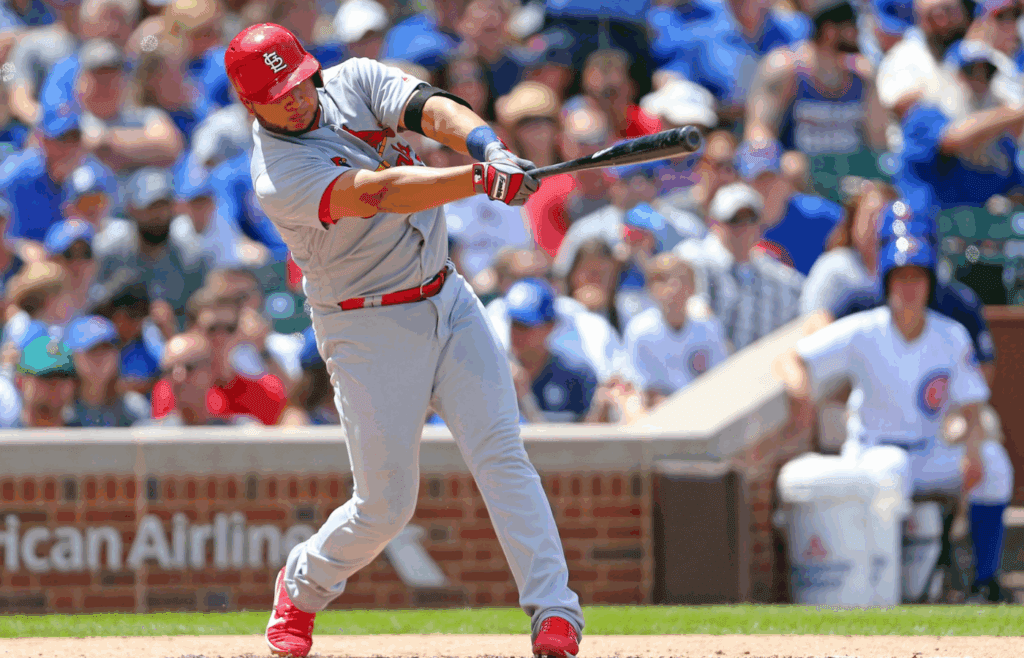 Jun 3, 2017; Chicago, IL, USA; St. Louis Cardinals third baseman Jhonny Peralta (27) hits a single during the fourth inning against the Chicago Cubs at Wrigley Field. Mandatory Credit: Dennis Wierzbicki-Imagn Images