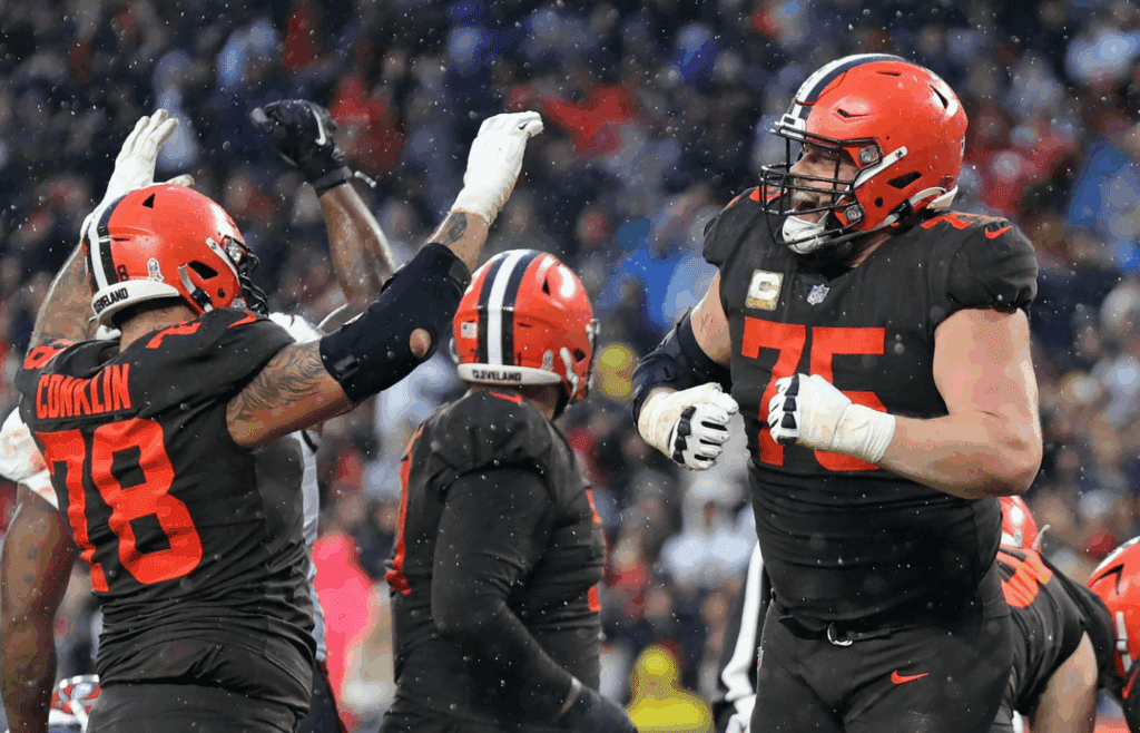 Browns guard Joel Bitonio (75) and tackle Jack Conklin (78) celebrate after Nick Chubb scored the game-winning touchdown in overtime against the Tampa Bay Buccaneers on Nov. 27, 2022, in Cleveland, Ohio