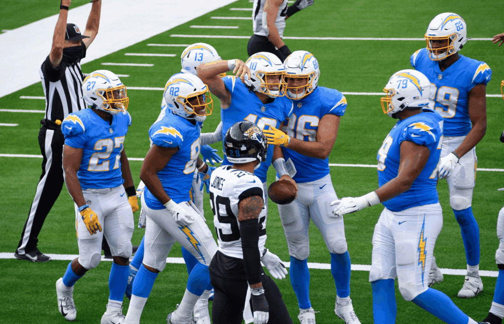 Oct 25, 2020; Inglewood, California, USA; Los Angeles Chargers quarterback Justin Herbert (10) celebrates with teammates after scoring a third quarter touchdown against the Jacksonville Jaguars at SoFi Stadium. Mandatory Credit: Robert Hanashiro-Imagn Images