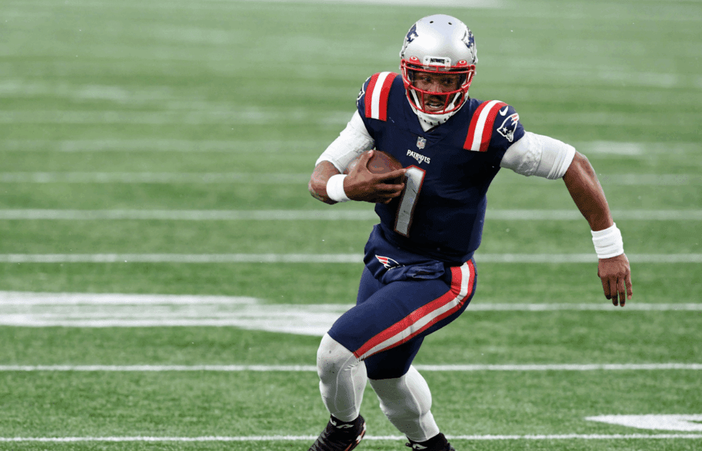 Jan 3, 2021; Foxborough, Massachusetts, USA; New England Patriots quarterback Cam Newton (1) runs with the ball against the New York Jets during the third quarter at Gillette Stadium. Mandatory Credit: Brian Fluharty-Imagn Images
