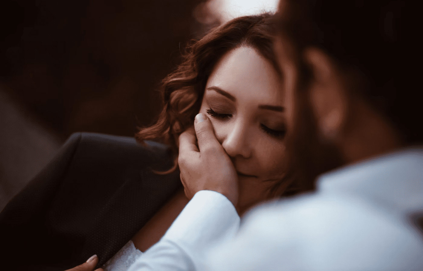 Man holding face of Woman and said "You look tired"