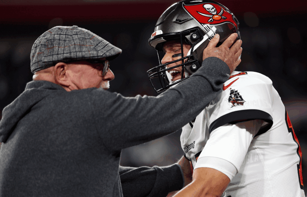 Jan 16, 2023; Tampa, Florida, USA; Tampa Bay Buccaneers senior football consultant Bruce Arians reacts with quarterback Tom Brady (12) against the Dallas Cowboys during a wild card game at Raymond James Stadium. Mandatory Credit: Nathan Ray Seebeck-Imagn Images