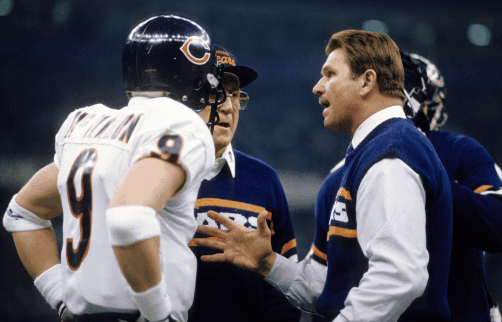 Jan 26, 1986; New Orleans, LA, USA; FILE PHOTO; Chicago Bears head coach Mike Ditka (right) and offensive coordinator Ed Hughes (center) talk to quarterback Jim McMahon (9) during Super Bowl XX against the New England Patriots at the Superdome. The Bears defeated the Patriots 46-10. Mandatory Credit: Manny Rubio-Imagn Images