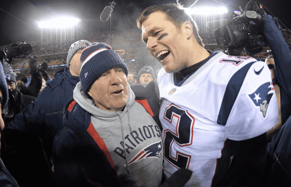 Jan 20, 2019; Kansas City, MO, USA; New England Patriots quarterback Tom Brady (12) celebrates with coach Bill Belichick after the AFC Championship game against the Kansas City Chiefs at Arrowhead Stadium. The Patriots defeated the Chiefs 37-31 in overtime to advance to fifth Super Bowl in eight seasons. Mandatory Credit: Kirby Lee-Imagn Images