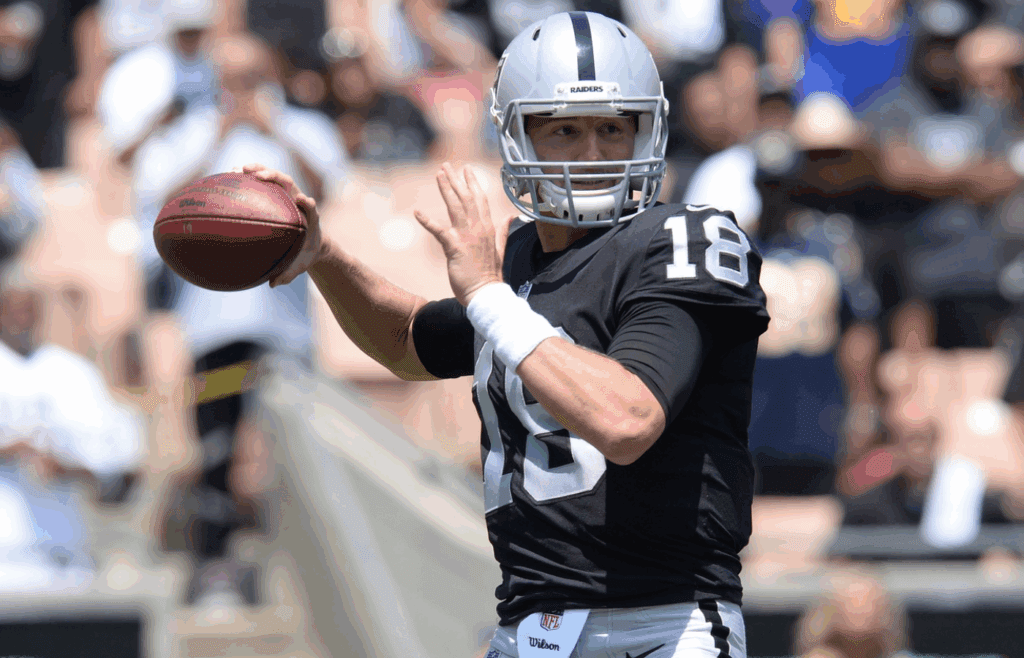 August 18, 2018; Los Angeles, CA, USA; Oakland Raiders quarterback Connor Cook (18) drops back to pass against the Los Angeles Rams during the first half at Los Angeles Memorial Coliseum. Mandatory Credit: Gary A. Vasquez-Imagn Images