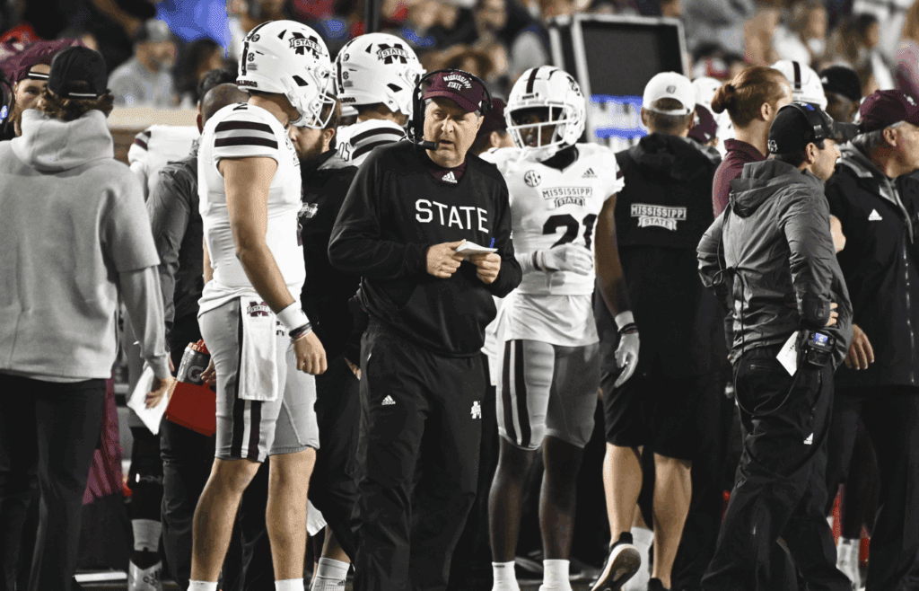 Nov 24, 2022; Oxford, Mississippi, USA; Mississippi State Bulldogs head coach Mike Leach speaks with quarterback Will Rogers (2) during the first quarter of the game against the Ole Miss Rebels at Vaught-Hemingway Stadium. Mandatory Credit: Matt Bush-Imagn Images