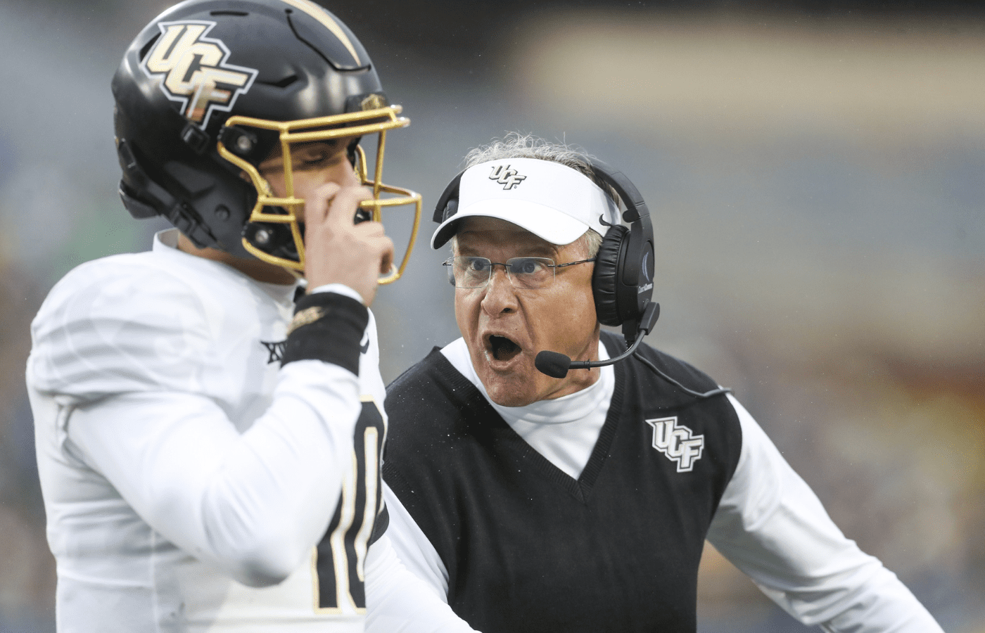 Nov 23, 2024; Morgantown, West Virginia, USA; UCF Knights head coach Gus Malzahn yells at quarterback Dylan Rizk (10) during the first quarter against the West Virginia Mountaineers at Mountaineer Field at Milan Puskar Stadium. Mandatory Credit: Ben Queen-Imagn Images