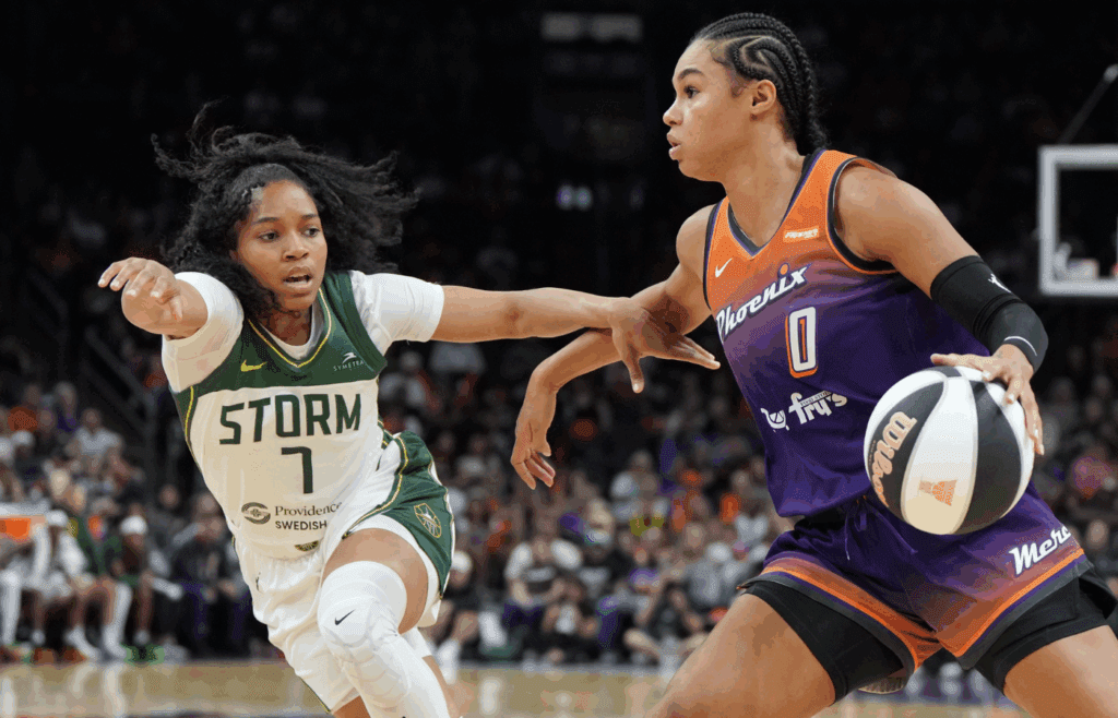 Jun 7, 2025; Phoenix, Arizona, USA; Phoenix Mercury forward Satou Sabally (0) drives on Seattle Storm guard Zia Cooke (7) in the second half at Footprint Center. Mandatory Credit: Rick Scuteri-Imagn Images