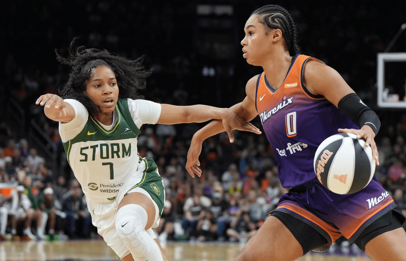 Jun 7, 2025; Phoenix, Arizona, USA; Phoenix Mercury forward Satou Sabally (0) drives on Seattle Storm guard Zia Cooke (7) in the second half at Footprint Center. Mandatory Credit: Rick Scuteri-Imagn Images