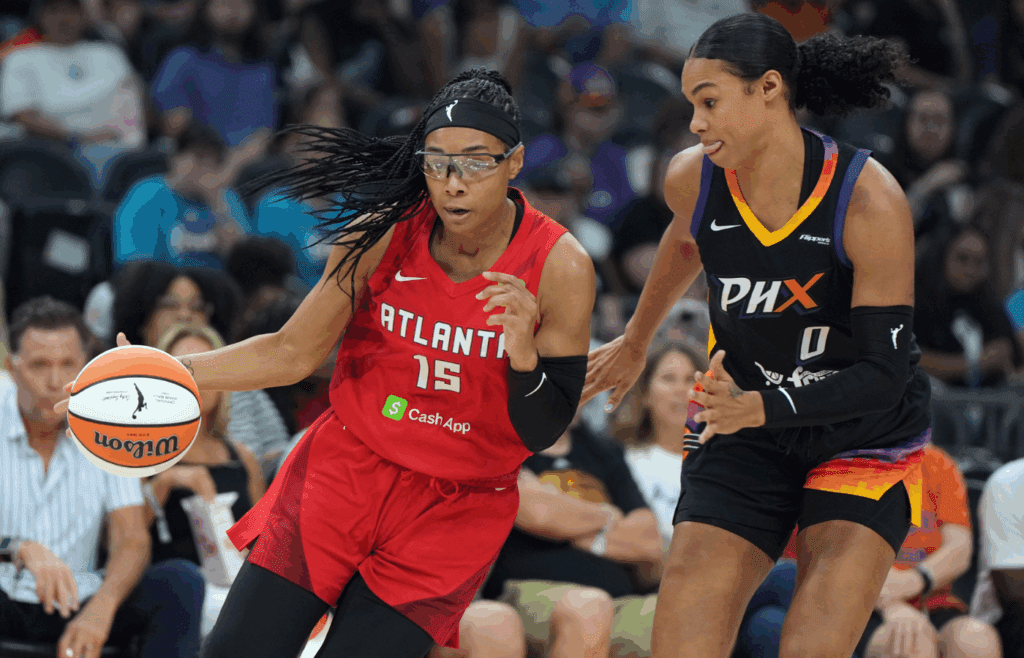 Jul 23, 2025; Phoenix, Arizona, USA; Atlanta Dream guard Allisha Gray (15) drives on Phoenix Mercury forward Satou Sabally (0) in the first half at Footprint Center. Mandatory Credit: Rick Scuteri-Imagn Images