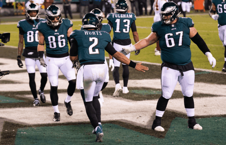 Jan 3, 2021; Philadelphia, Pennsylvania, USA; Philadelphia Eagles quarterback Jalen Hurts (2) celebrates with teammates after a touchdown run against the Washington Football Team during the second quarter at Lincoln Financial Field. Mandatory Credit: Bill Streicher-Imagn Images