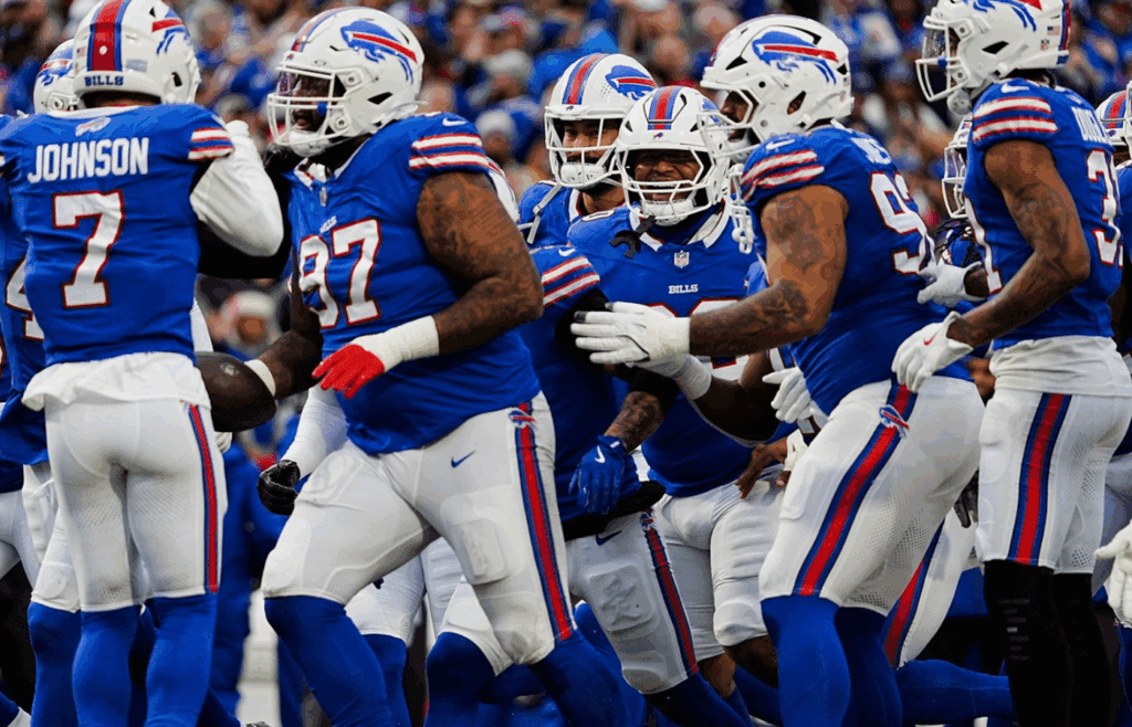 Buffalo Bills defensive tackle Jordan Phillips (97) celebrates with his team his intercepting New York Jets quarterback Aaron Rodgers (8) pass intended for a receiver during first half action at the Bills home game against the New York Jets at Highmark Stadium in Orchard Park on Dec. 29, 2024