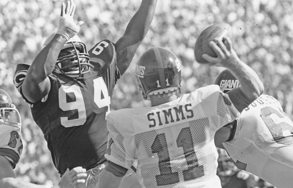 Green Bay Packers defensive ends Charles Martin (94) rushes Giants quarterback Phil Simms (11) on Sept. 15, 1985, at Lambeau Field in Green Bay, Wis. The Packers defeated the New York Giants 23-20. Gpg Historic Packers Vs Giants 09072022 0003