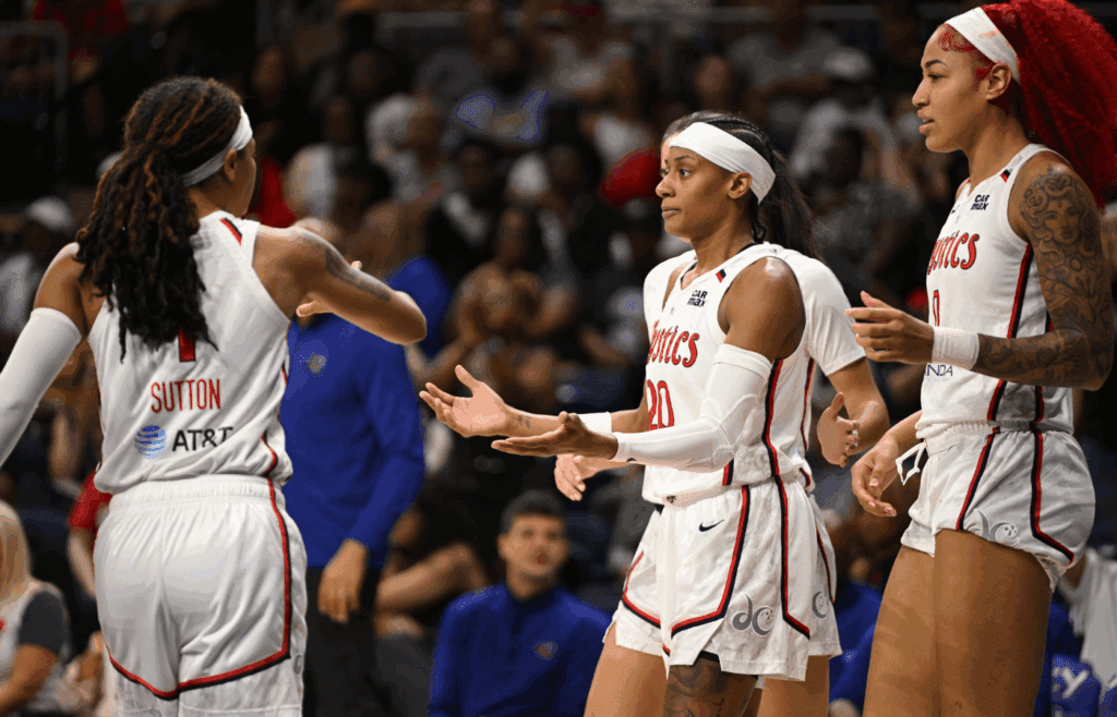 Jul 22, 2025; Washington, District of Columbia, USA; Washington Mystics guard Brittney Sykes (20) celebrates a play with guard Sug Sutton (1) and forward Shakira Austin (0) against the Los Angeles Sparks during the third quarter at CareFirst Arena. Mandatory Credit: Rafael Suanes-Imagn Images