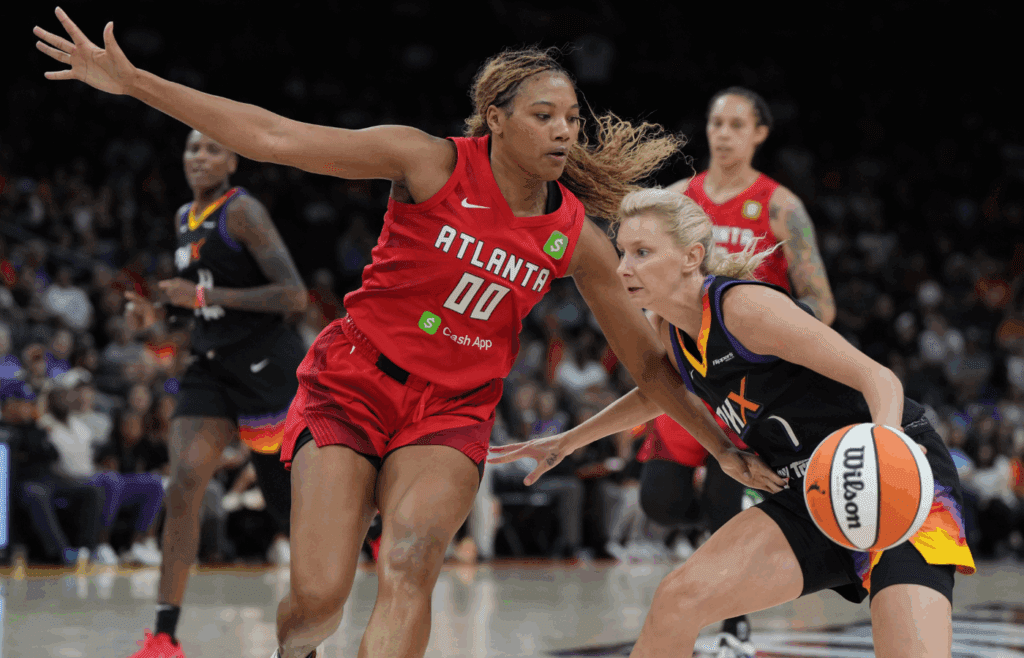 Jul 23, 2025; Phoenix, Arizona, USA; Phoenix Mercury guard Lexi Held (1) drives on Atlanta Dream forward Naz Hillmon (0) in the second half at Footprint Center. Mandatory Credit: Rick Scuteri-Imagn Images
