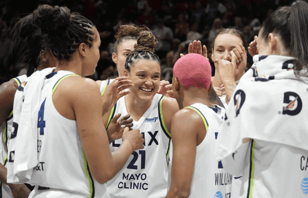 Jul 16, 2025; Minneapolis, Minnesota, USA; Minnesota Lynx guard Kayla McBride (21) and her team celebrate the win over the Phoenix Mercury at Target Center. Mandatory Credit: Bruce Kluckhohn-Imagn Images