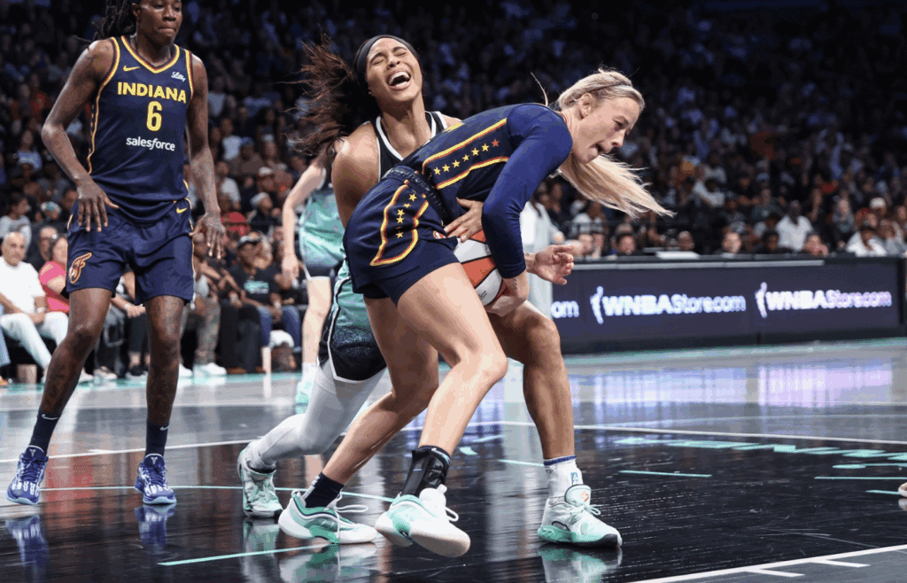 Jul 22, 2025; Brooklyn, New York, USA; New York Liberty forward Isabelle Harrison (21) and Indiana Fever guard Sophie Cunningham (8) fight for a loose ball in the second quarter at Barclays Center. Mandatory Credit: Wendell Cruz-Imagn Images