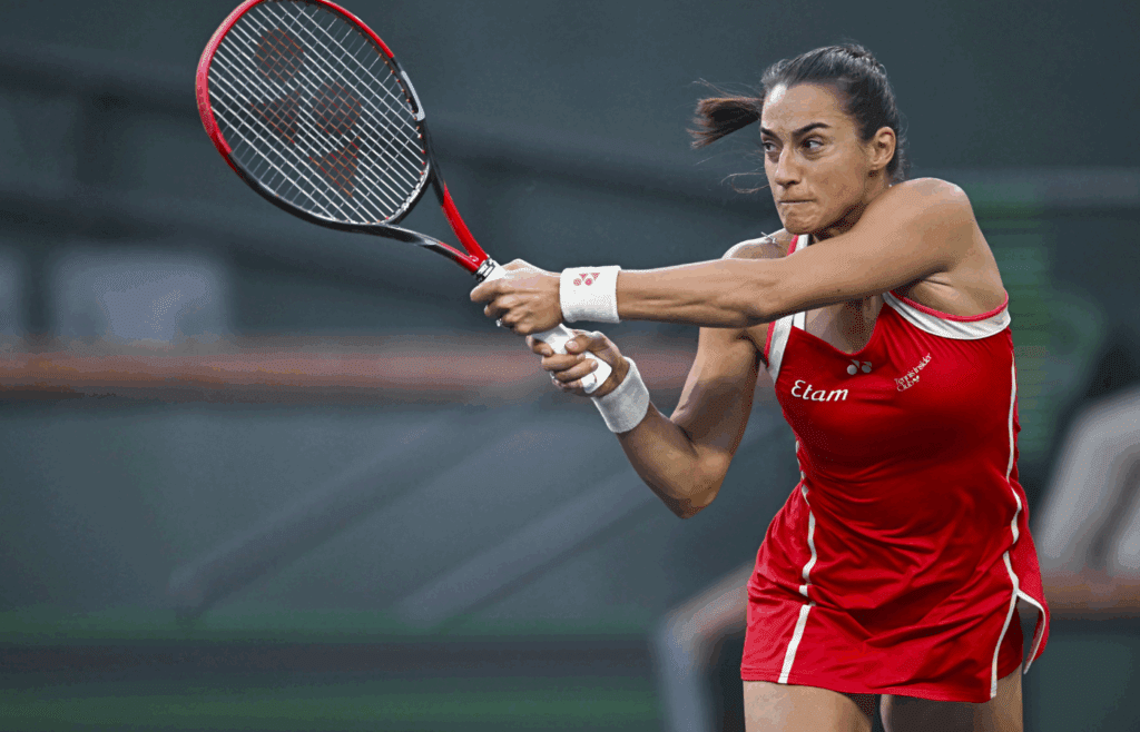 Mar 7, 2025; Indian Wells, CA, USA; Caroline Garcia (FRA) hits a ball against Iga Swiatek (POL) at Indian Well Tennis Garden. Mandatory Credit: Jonathan Hui-Imagn Images
