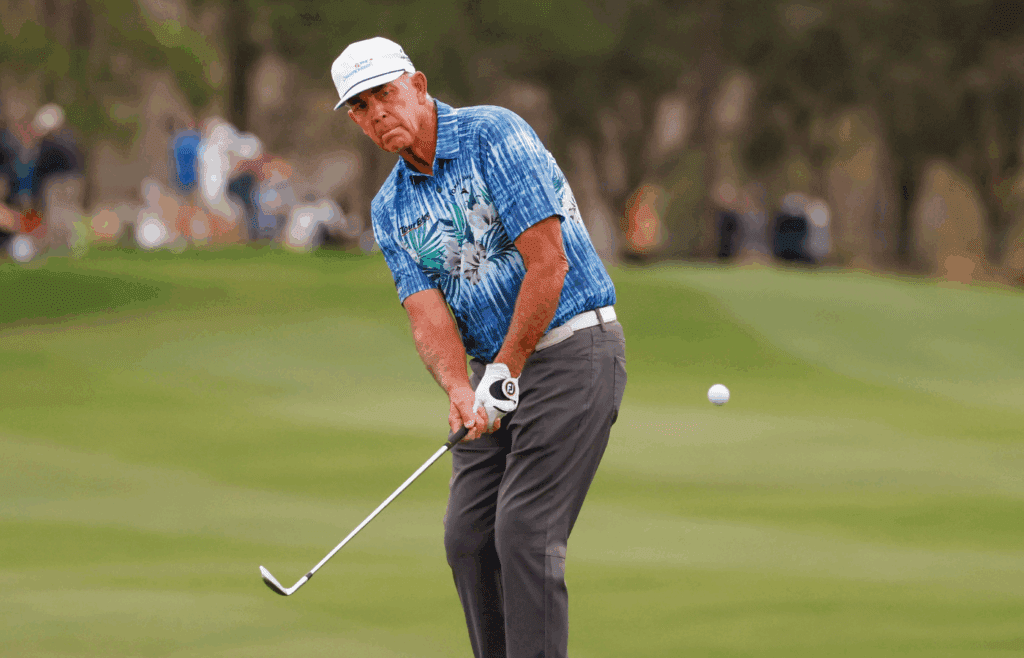 Dec 17, 2022; Orlando, Florida, USA; Tom Lehman chips onto the 18th green during the first round of the PNC Championship golf tournament at Ritz Carlton Golf Club Grande Lakes Orlando Course. Mandatory Credit: Reinhold Matay-Imagn Images