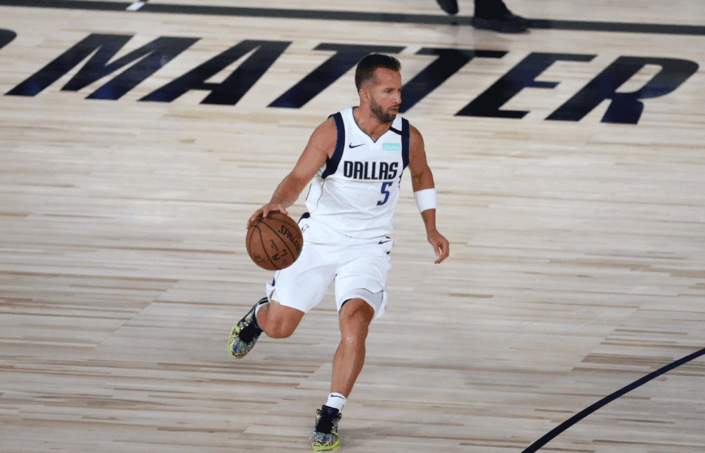 Aug 4, 2020; Lake Buena Vista, Florida, USA; Dallas Mavericks guard J.J. Barea (5) brings the ball upcourt against the Sacramento Kings during the first half of a NBA basketball game in the HP Field House at the ESPN Wide World of Sports Complex. Mandatory Credit: Kim Klement-Imagn Images