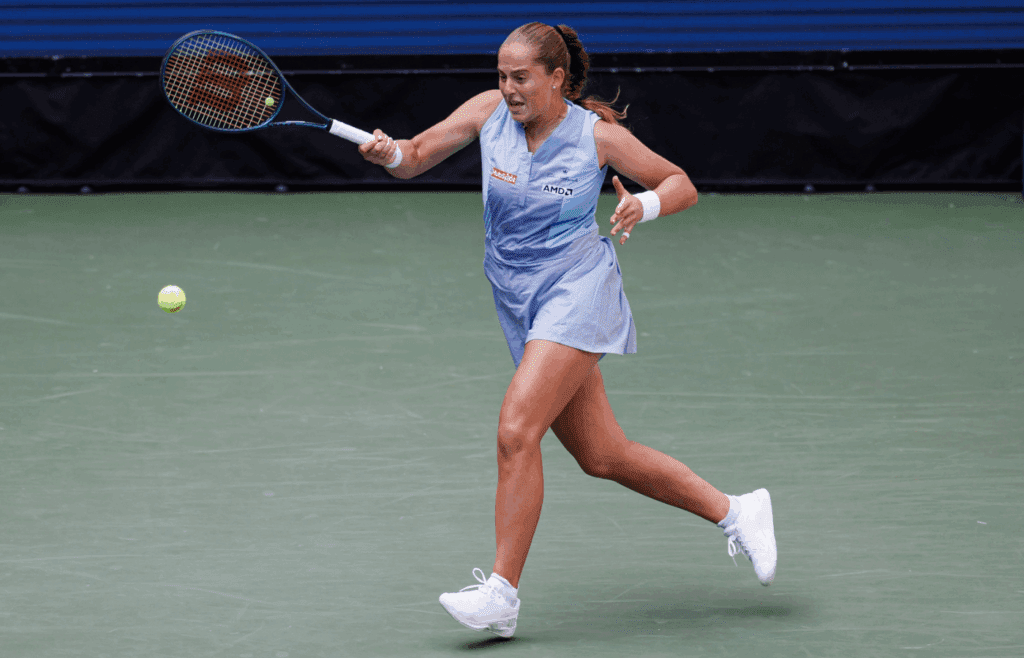 Aug 27, 2024; Flushing, NY, USA; Jelena Ostapenko of Latvia in action against Naomi Osaka of Japan in the first round of the women’s singles in the US Open at the USTA Billie Jean King Tennis Center. Mandatory Credit: Mike Frey-Imagn Images