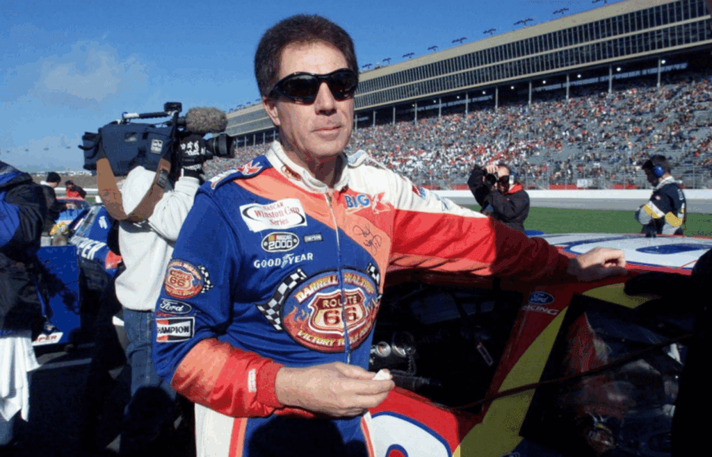 Darrell Waltrip munches on an energy bar before the start of his final NASCAR race after 28 years of racing. The race is the NAPA 500 at the Atlanta Motor Speedway Nov. 20, 2000. Title Waltrip S Final Race