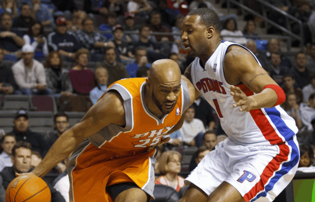 Jan 22, 2011; Auburn Hills, MI, USA; Phoenix Suns shooting guard Vince Carter (25) drives past Detroit Pistons shooting guard Tracy McGrady (1) in the first quarter of an NBA game at The Palace. Mandatory Credit: Rick Osentoski-Imagn Images