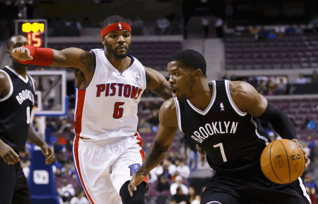Feb 7, 2014; Auburn Hills, MI, USA; Brooklyn Nets shooting guard Joe Johnson (7) moves the ball defended by Detroit Pistons small forward Josh Smith (6) in the first half at The Palace of Auburn Hills. Mandatory Credit: Rick Osentoski-Imagn Images
