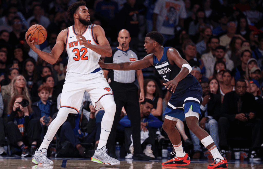 Oct 13, 2024; New York, New York, USA; New York Knicks center Karl-Anthony Towns (32) looks to pass as Minnesota Timberwolves guard Anthony Edwards (5) defends during the second half at Madison Square Garden. Mandatory Credit: Vincent Carchietta-Imagn Images