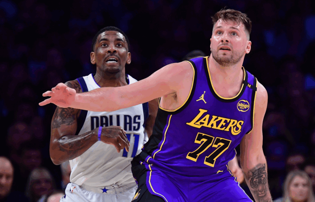 Feb 25, 2025; Los Angeles, California, USA; Los Angeles Lakers guard Luka Doncic (77) and Dallas Mavericks guard Kyrie Irving (11) attempt to gain control during the first quarter at Crypto.com Arena. Mandatory Credit: Gary A. Vasquez-Imagn Images