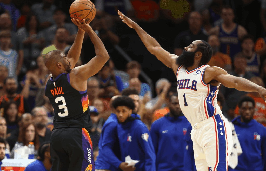 Mar 27, 2022; Phoenix, Arizona, USA; Phoenix Suns guard Chris Paul (3) against Philadelphia 76ers guard James Harden (1) at Footprint Center. Mandatory Credit: Mark J. Rebilas-Imagn Images